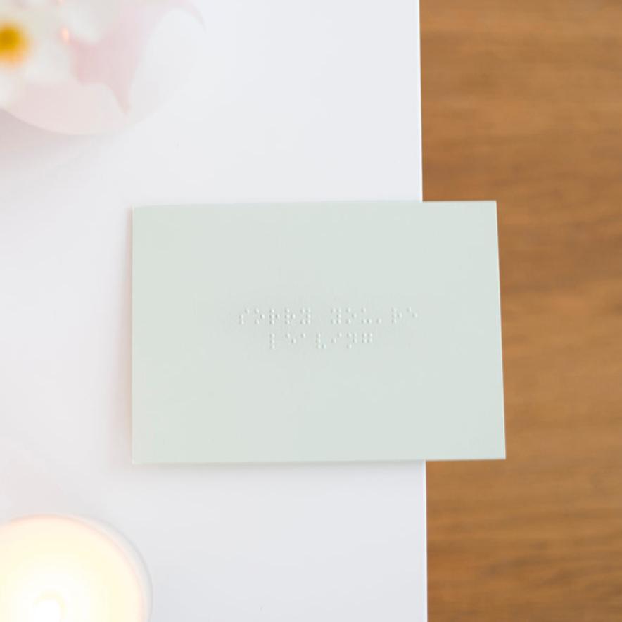 A pastel green card saying sorry you're leaving in grade one, lower case braille.