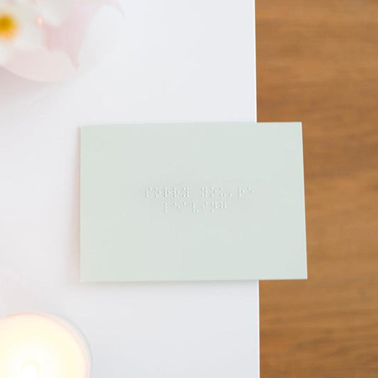 A pastel green card saying sorry you're leaving in grade one, lower case braille.