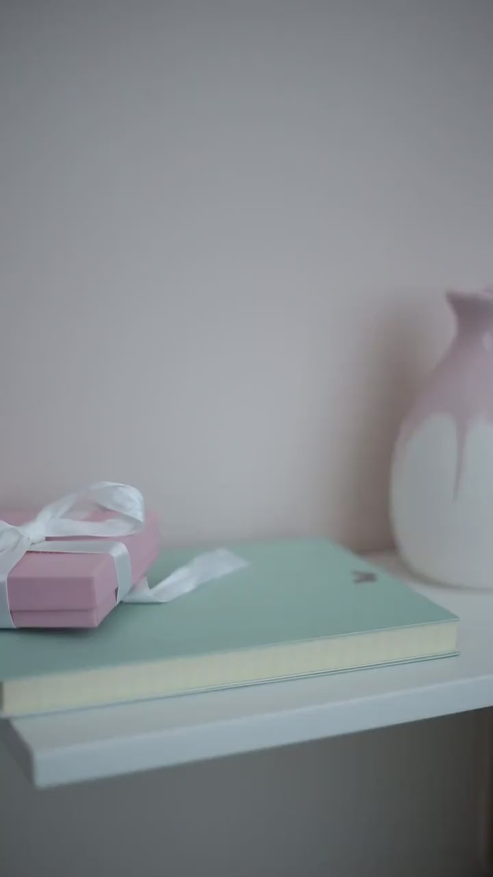 A video of a pastel purple card with Happy Mother's Day written in lower case braille.