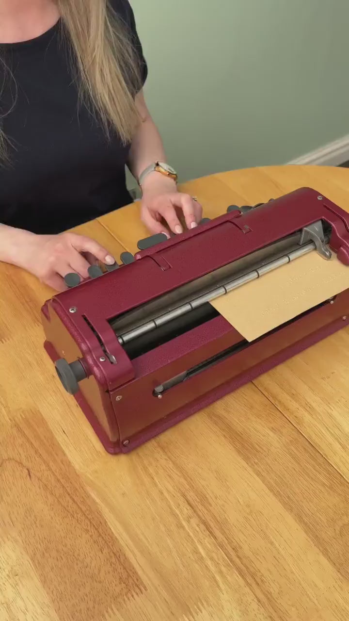 A video of Hayley typing at a Perkins brailler.