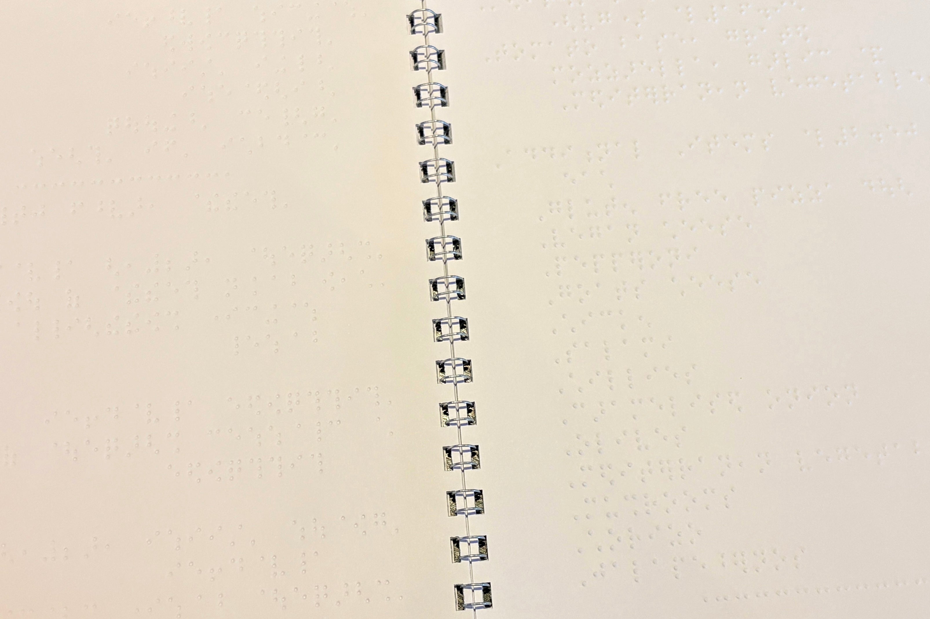 Close up of a wire bound braille menu.
