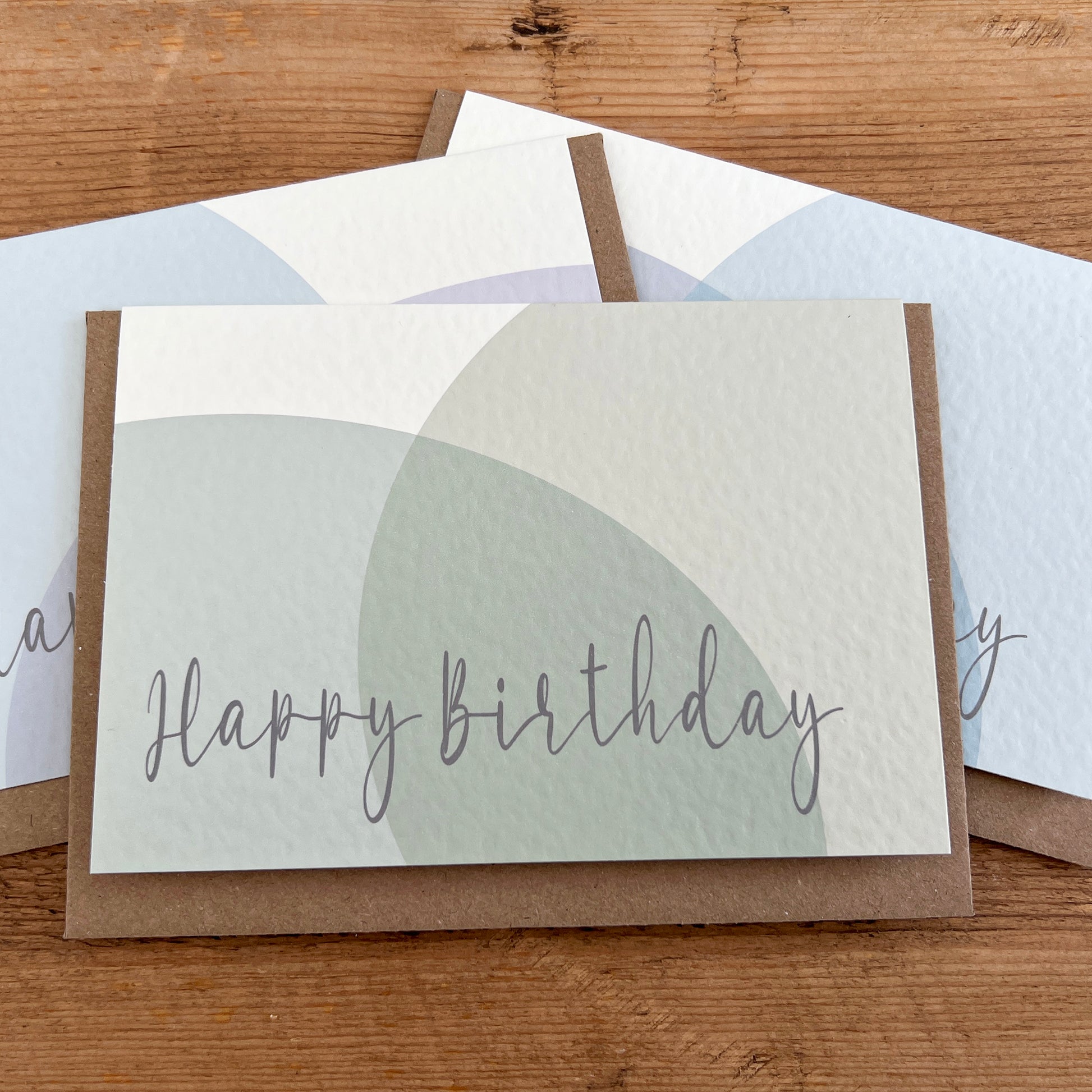 Set of pastel birthday cards with 'Happy Birthday' in script and Braille underneath each.