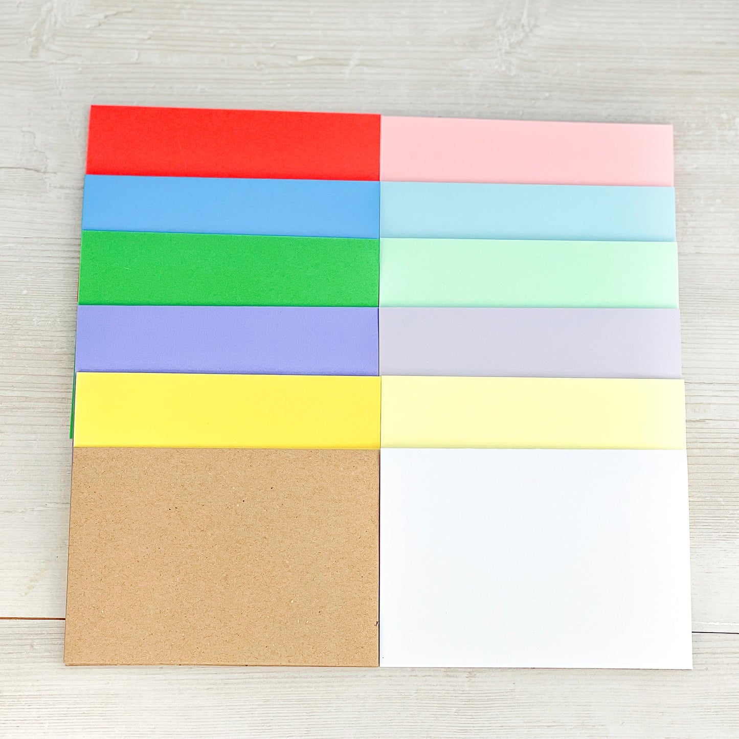 12 blank cards in these colours: vibrant red, blue, green, purple, yellow, pastel pink, blue, green, purple, yellow, white and recycled kraft brown