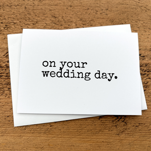 A white A6 card with text that reads: on your wedding day written in black typewriter style font.