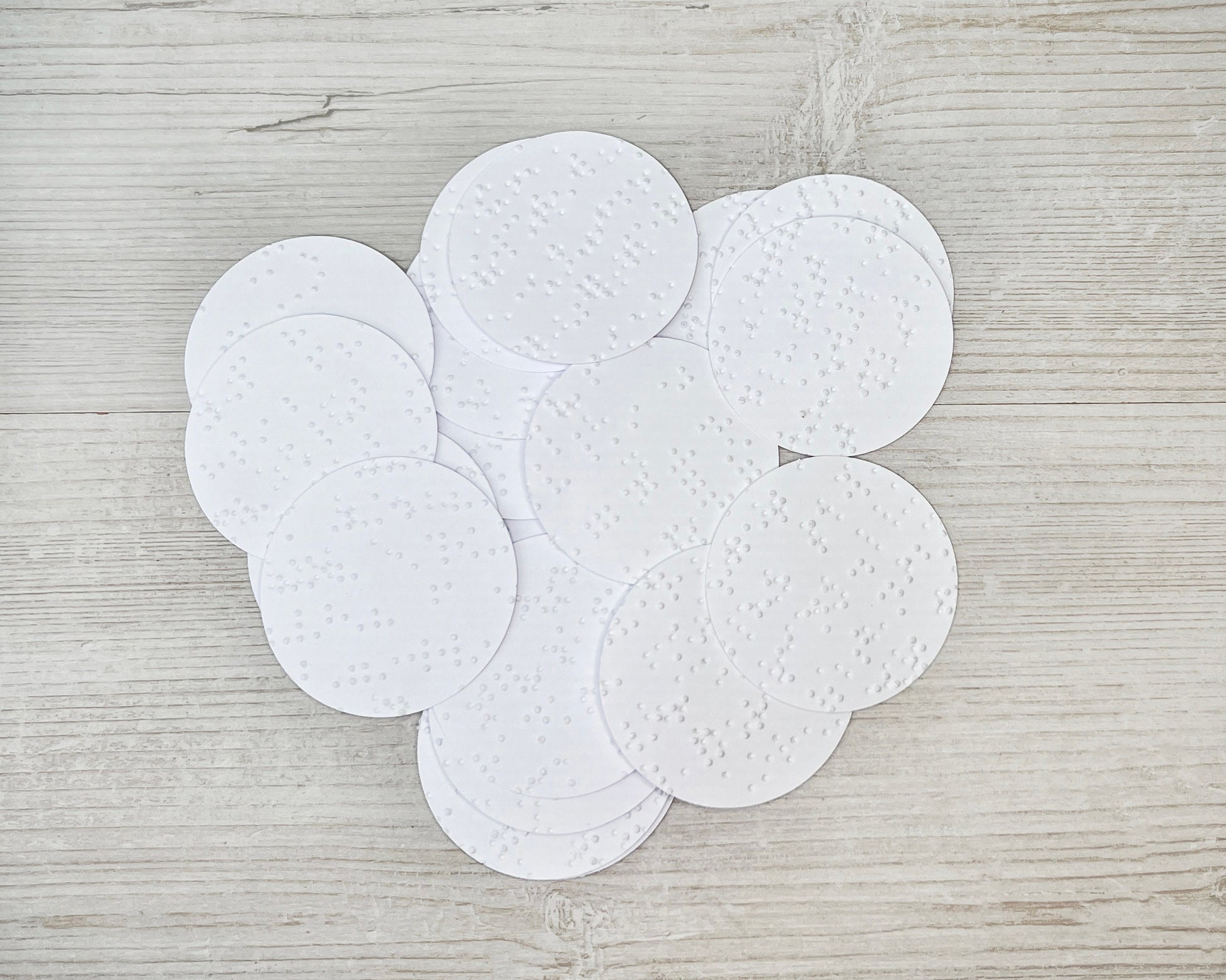 5cm circles of white braille paper.