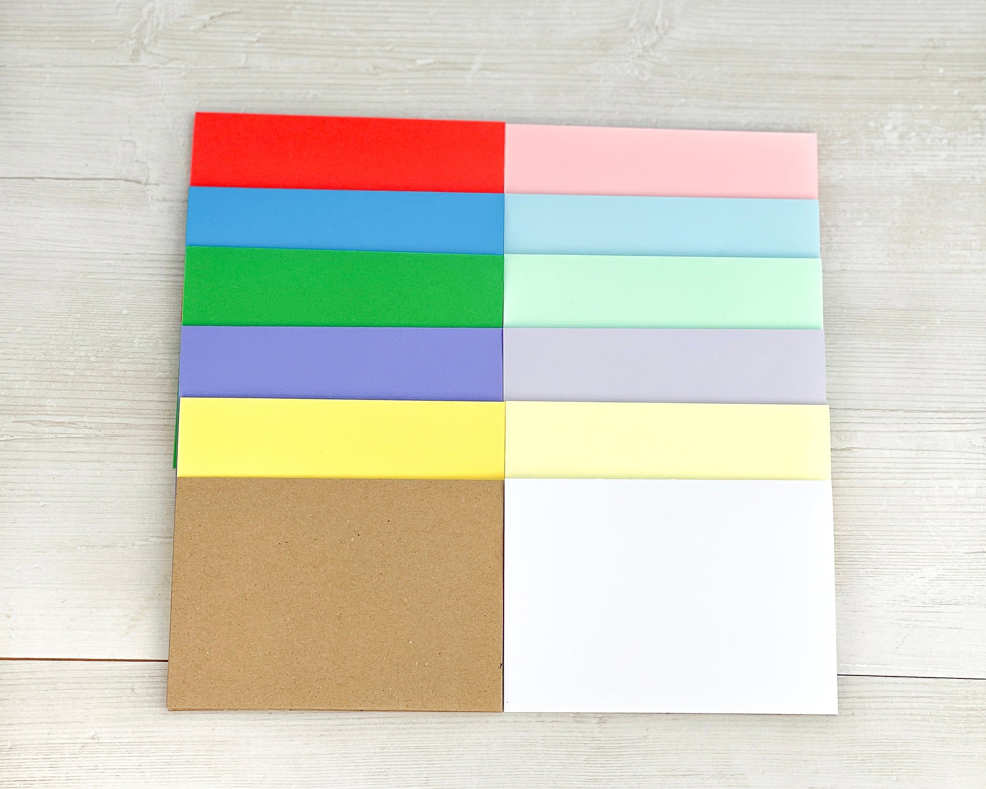 12 blank cards in these colours: vibrant red, blue, green, purple, yellow, pastel pink, blue, green, purple, yellow, white and kraft brown