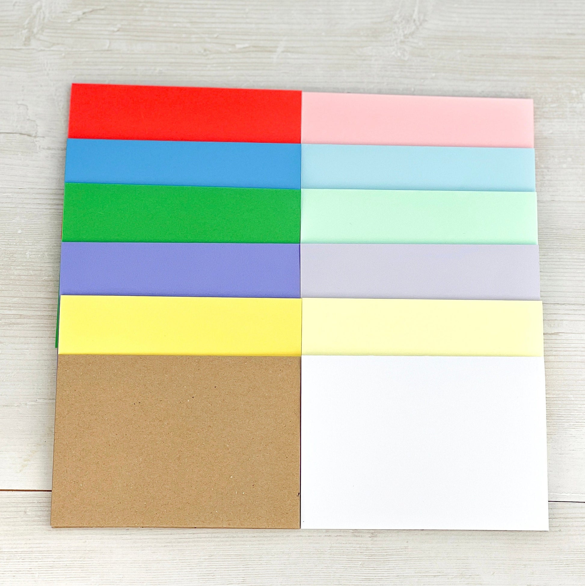 12 blank cards in these colours: vibrant red, blue, green, purple, yellow, pastel pink, blue, green, purple, yellow, white and recycled kraft brown